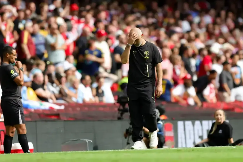 Enzo Maresca Premier League verdict: Pep Guardiola looking dejected while wearing Manchester City training gear.