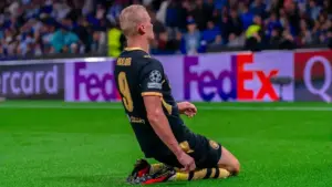 Erling Haaland celebrating on his knees in a Manchester City kit